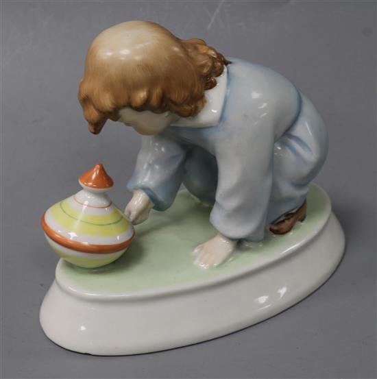A Zsolnay ceramic model of a young child with a spinning top height 12cm